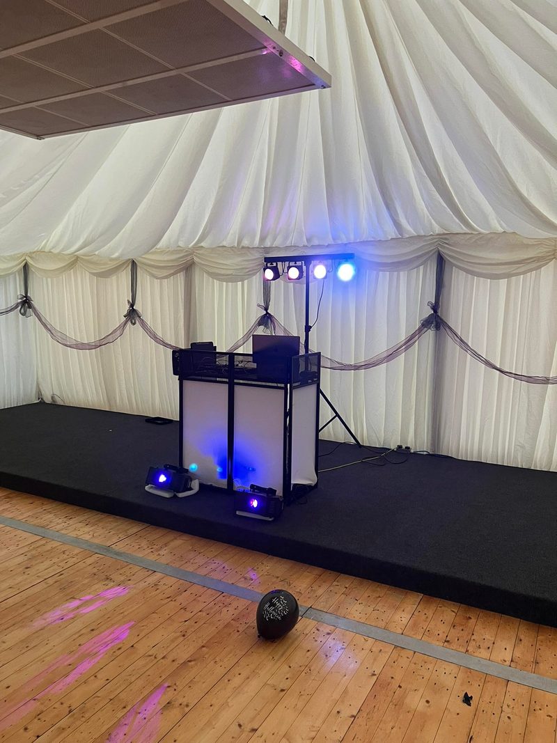 DJ rig and lighting ready in a draped marquee